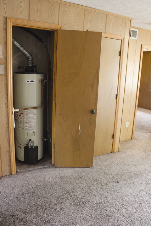 A Spa pool heater is installed in a wooden room.