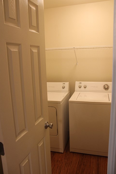 a door leading into a laundry room with two washing machines