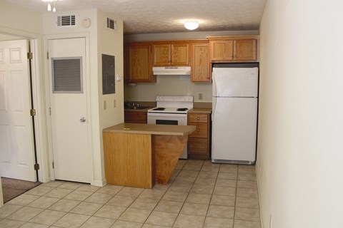 a kitchen with wooden cabinets and a white refrigerator