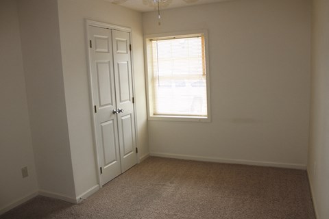an empty room with a door and a window