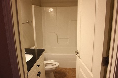 A small bathroom with a toilet and a walk in shower.