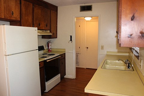 a kitchen with a stove refrigerator and a sink