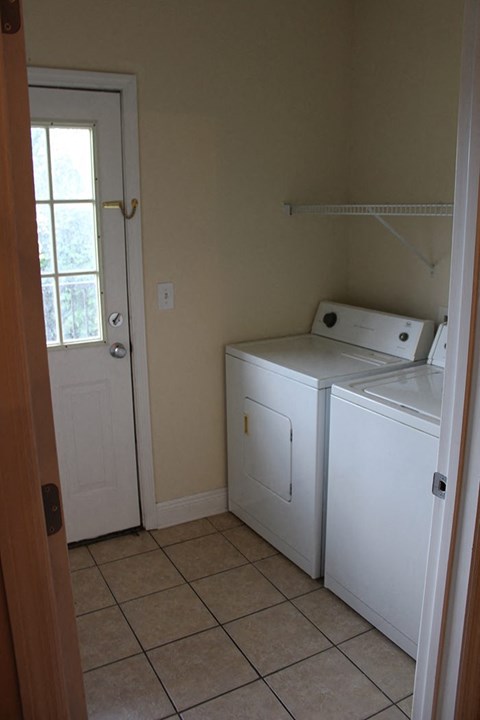 A small kitchen with a sink and a window.