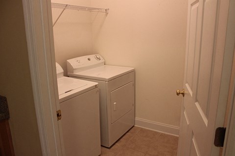 a washer and dryer in a small room with a door
