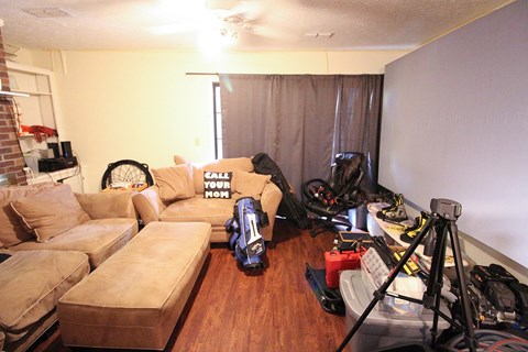 a living room filled with furniture and a camera tripod