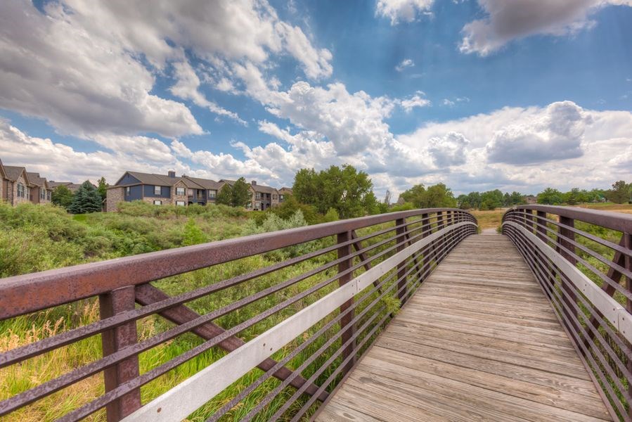 a bridge with a cloudy sky in the background