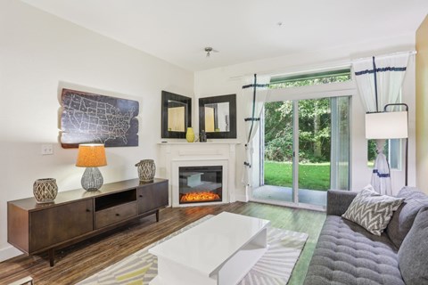 a living room with a couch and a fireplace and a sliding glass door