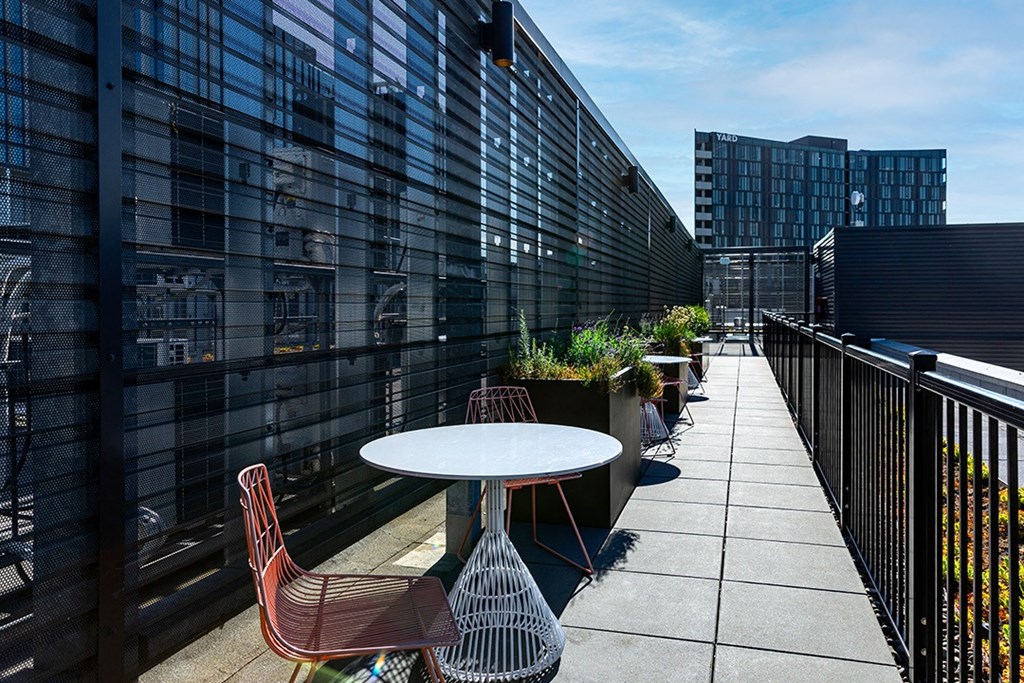 a patio with a table and chairs on a balcony