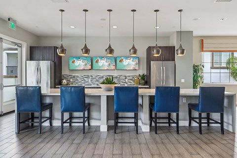A kitchen with a table and chairs.