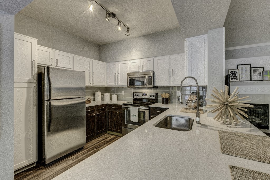 a kitchen with stainless steel appliances and white cabinets