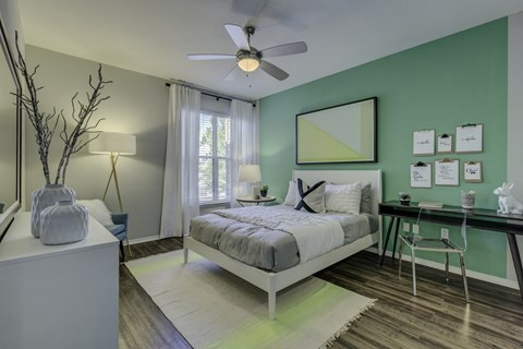 a bedroom with a bed and a ceiling fan
