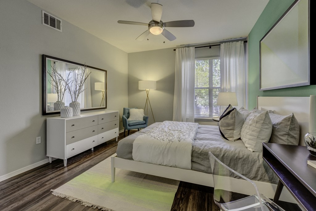 a bedroom with a bed and a ceiling fan