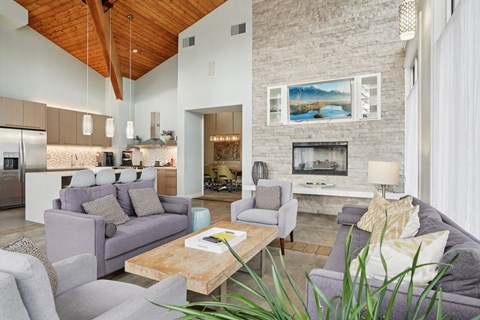 A modern living room with a grey couch and a wooden coffee table.