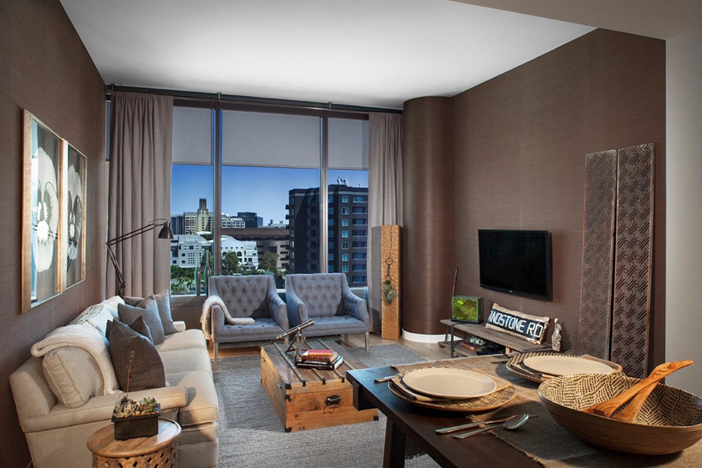 a living room filled with furniture and a large window