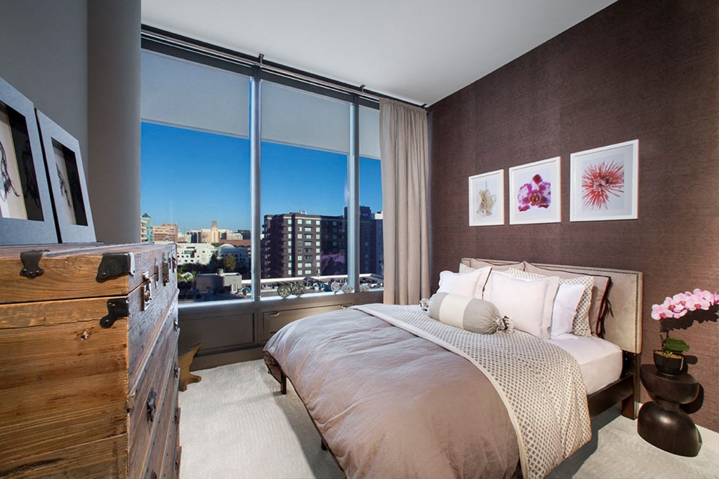 a bedroom with a bed and a large window