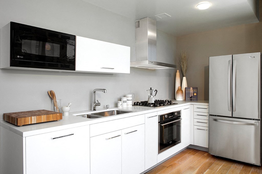a kitchen with white cabinets and stainless steel appliances