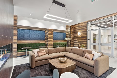 A modern living room with a large sectional sofa and a fireplace.