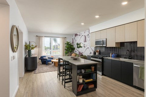 A modern kitchen with a dining table and chairs.