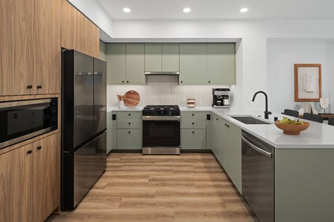 A modern kitchen with wooden cabinets and stainless steel appliances.