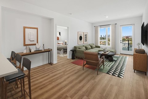 A living room with a couch, chairs, and a table.