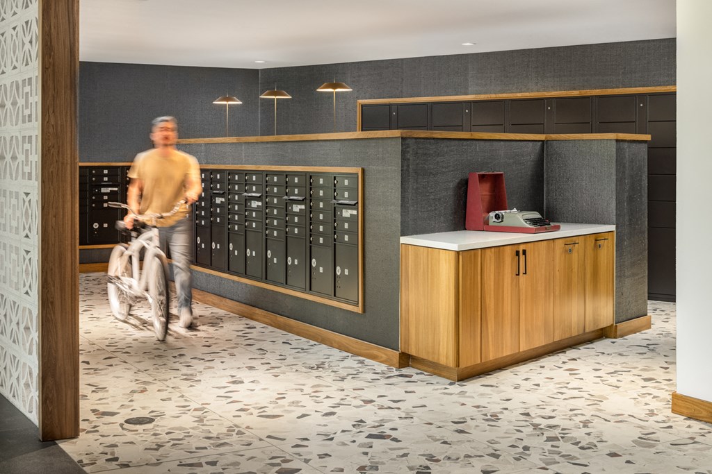 a man riding a bike in a locker room with a bike rack