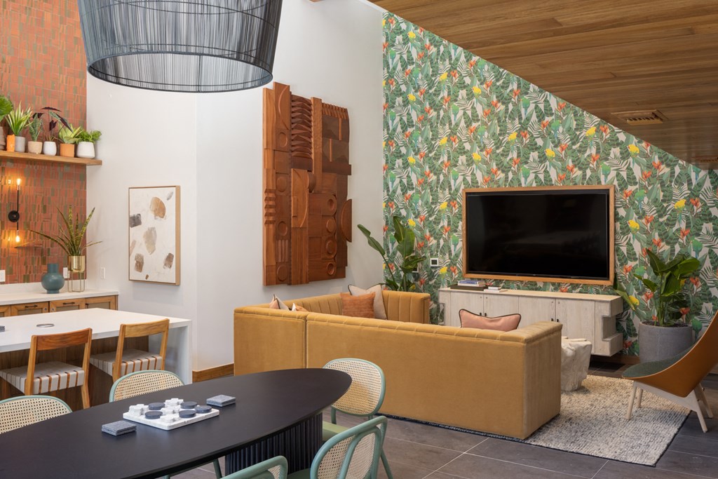 a living room with a television and a table and chairs