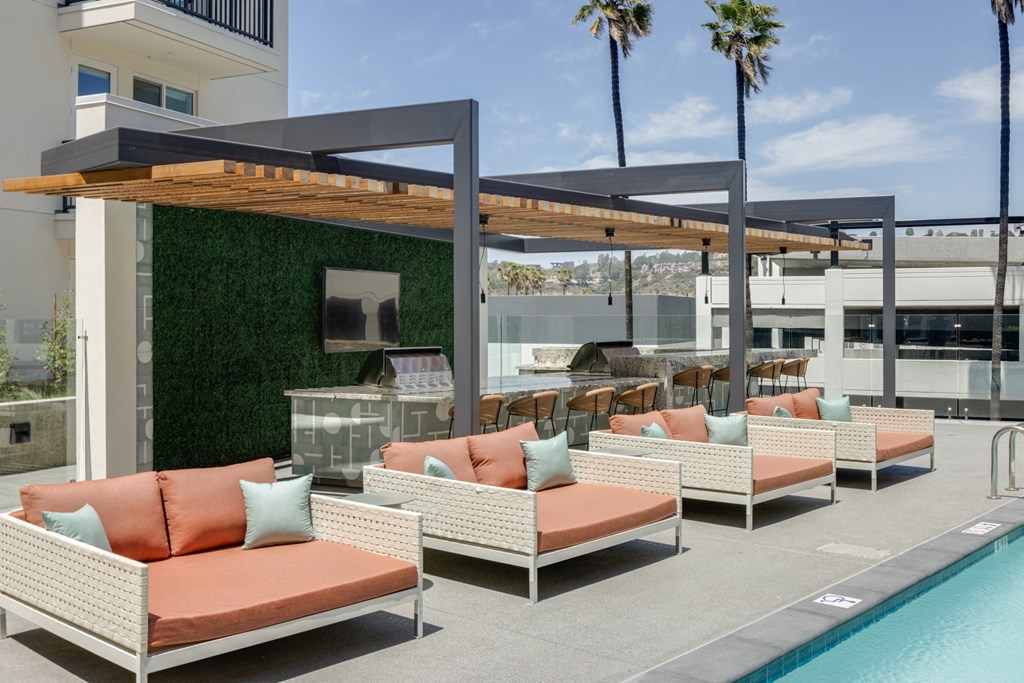 a group of couches and chairs next to a pool