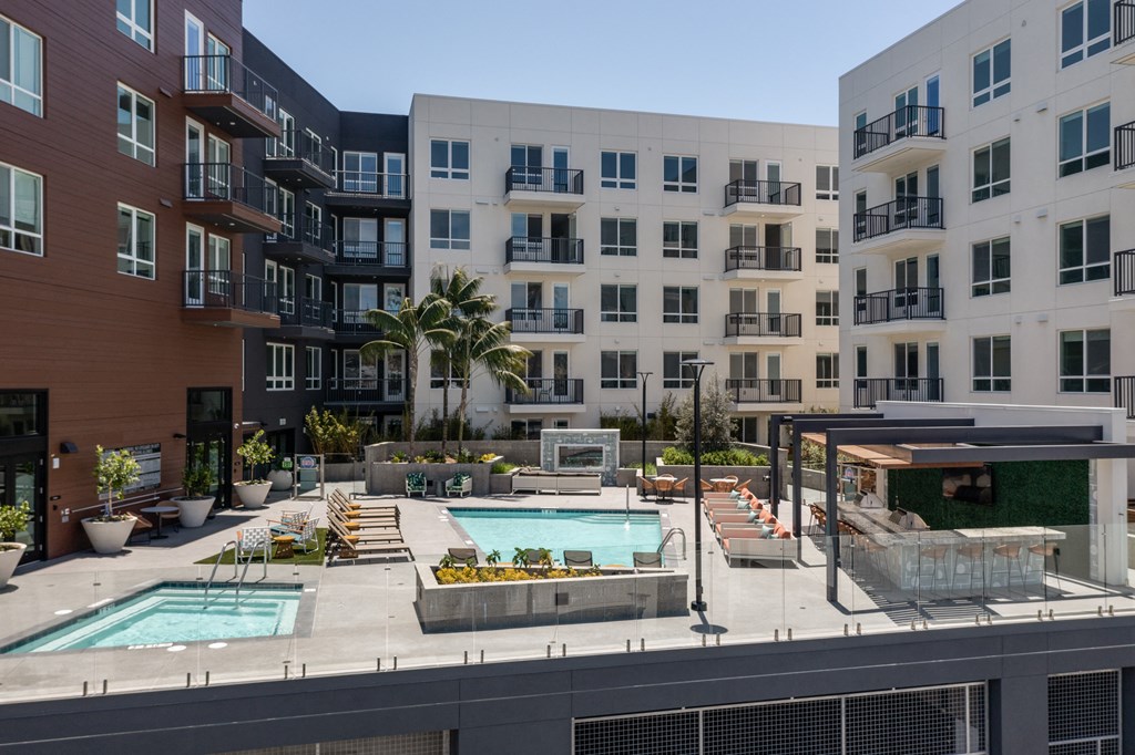 an apartment building with two swimming pools in front of it