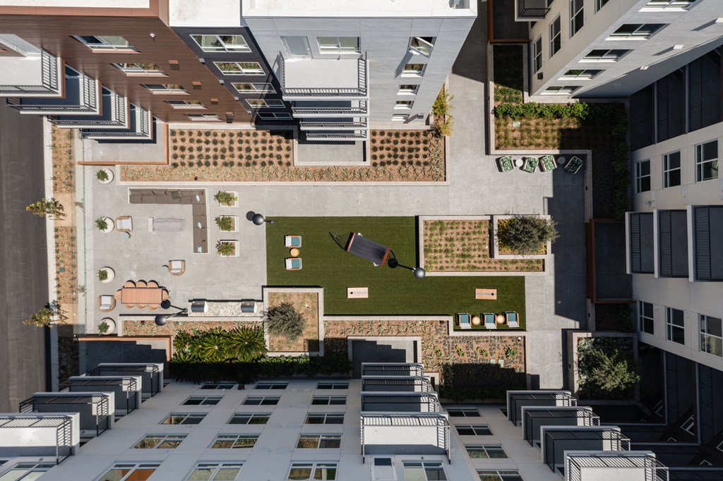 an aerial view of a building with a courtyard and rooftop terraces