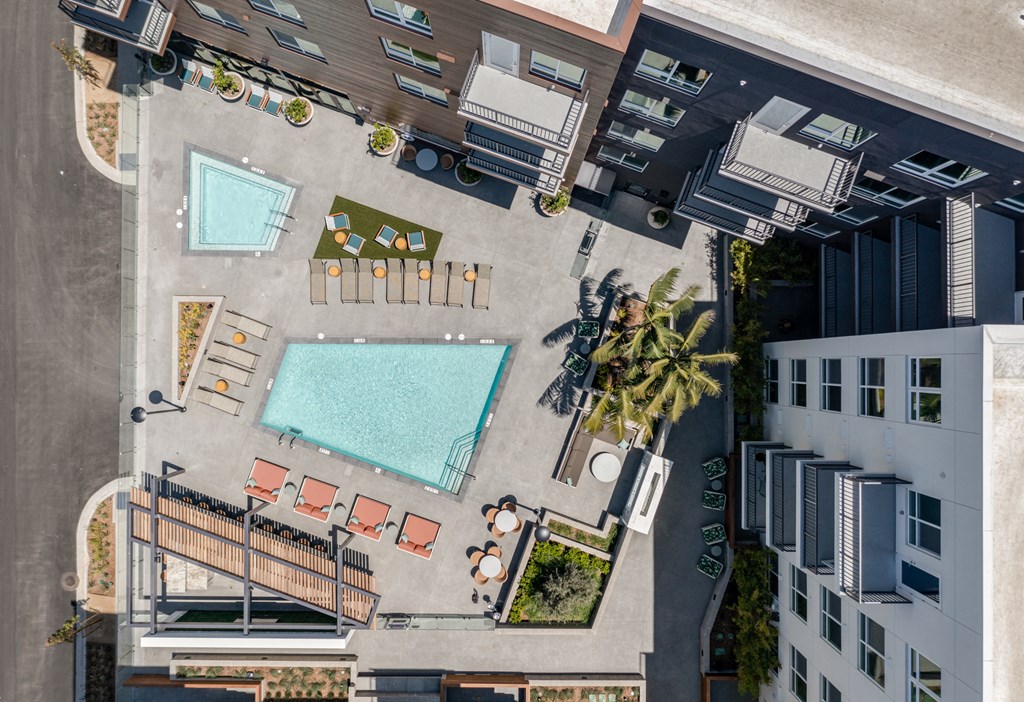 an overhead view of a swimming pool on the side of a building