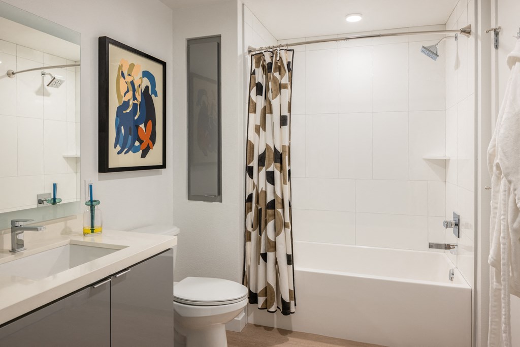 a bathroom with a shower and a sink and a toilet