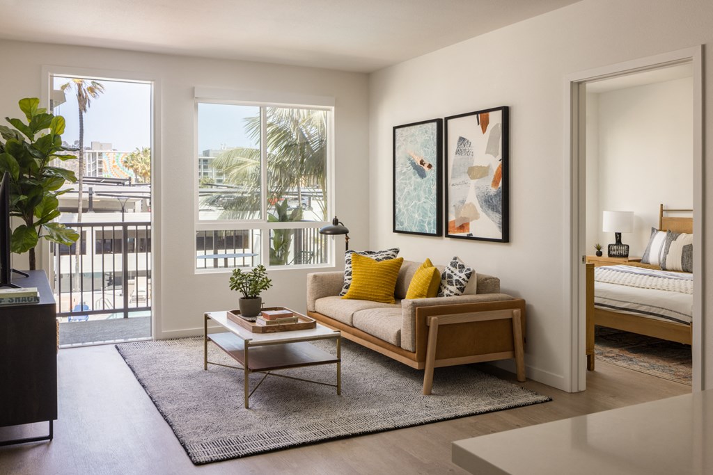 a living room with a couch and a table    and a balcony