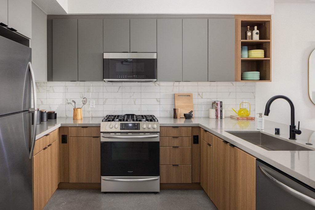 a kitchen with stainless steel appliances and wooden cabinets