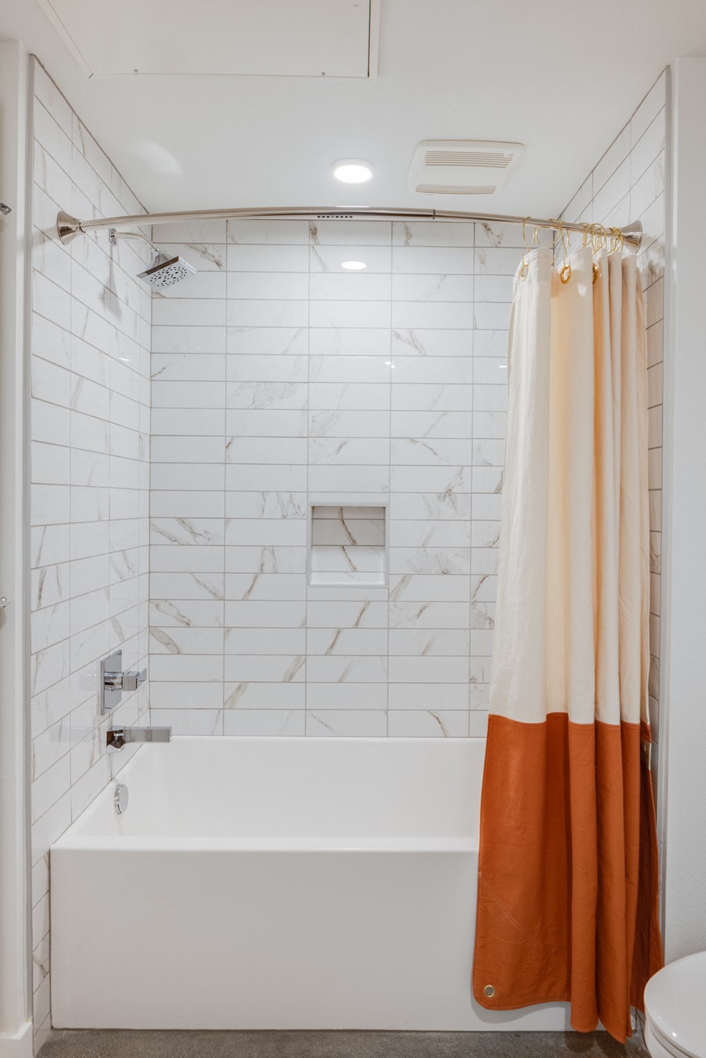 a white bathroom with a shower curtain and a tub