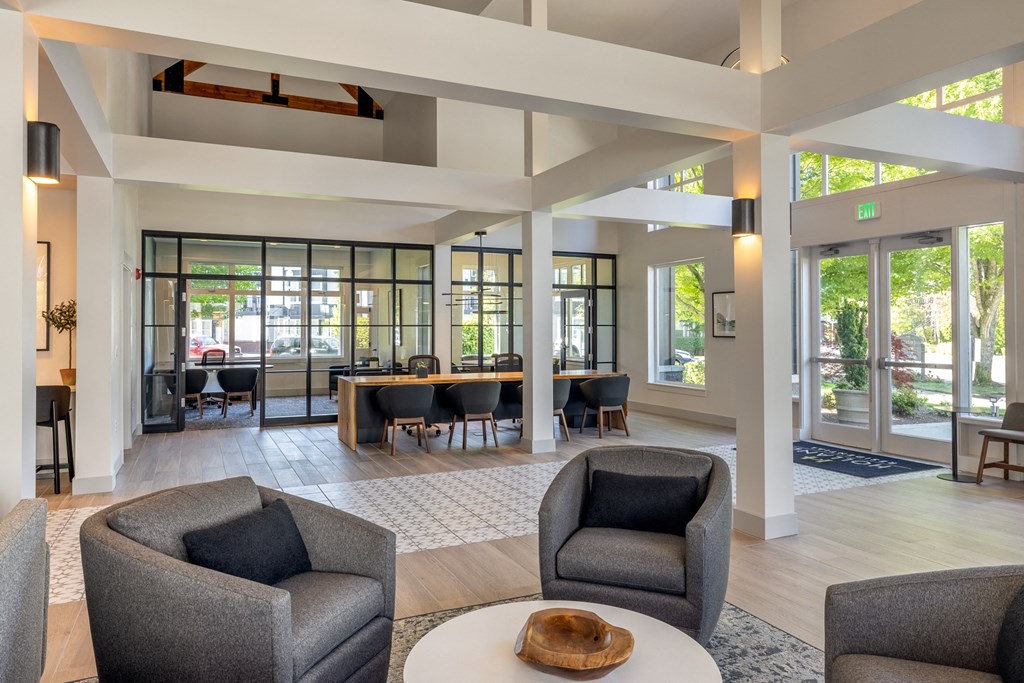 a room with chairs and a table in the middle of it