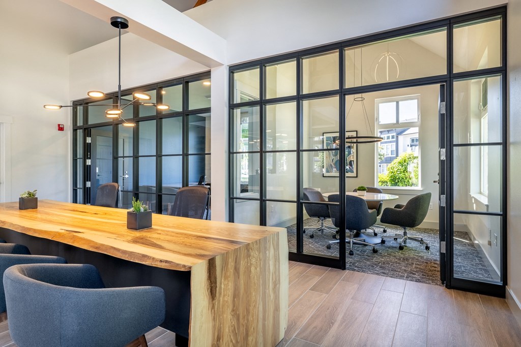 a conference room with glass walls and a wooden table