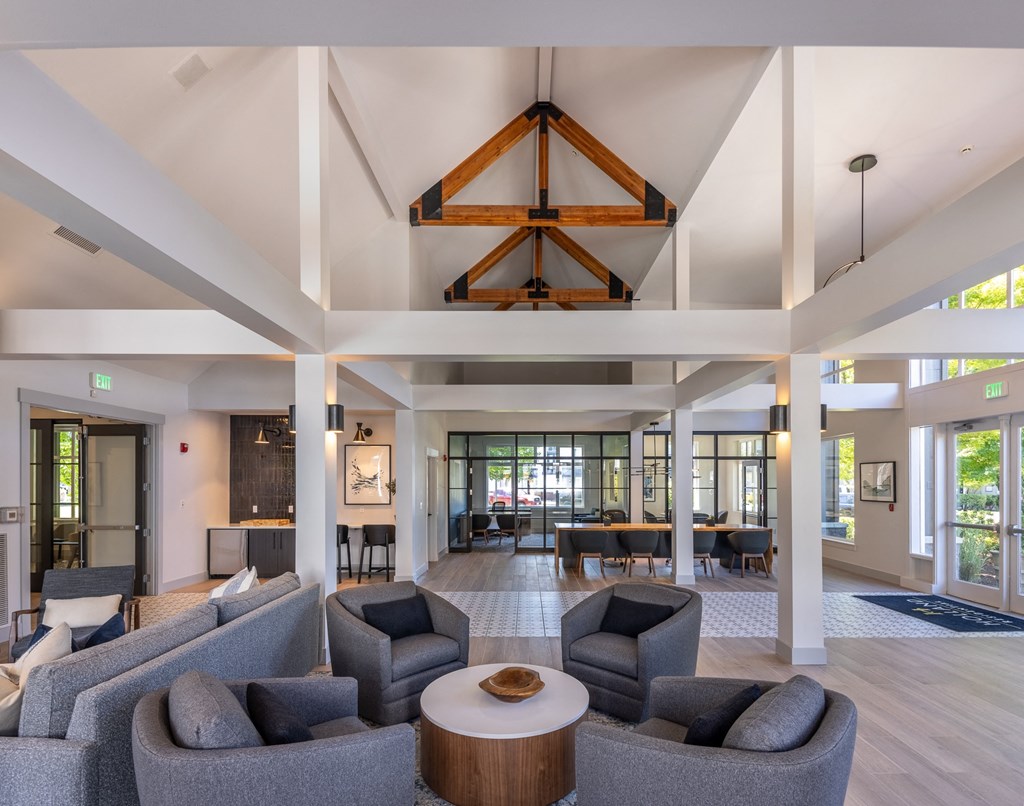 a large living room with couches and chairs and a table