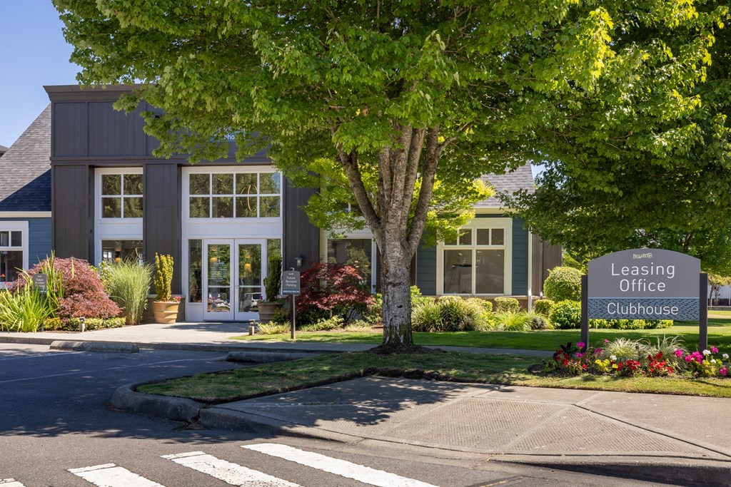 a building with a leasing office sign in front of it