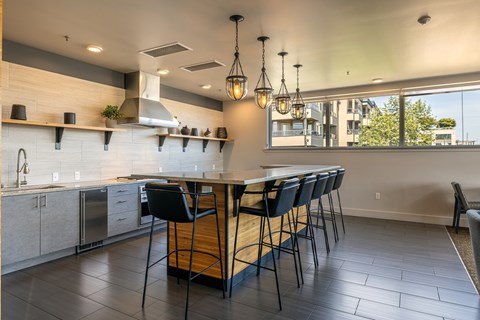 A modern kitchen with a large island and bar stools.