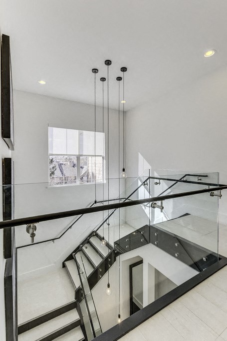 modern stairwell in a house with glass railings