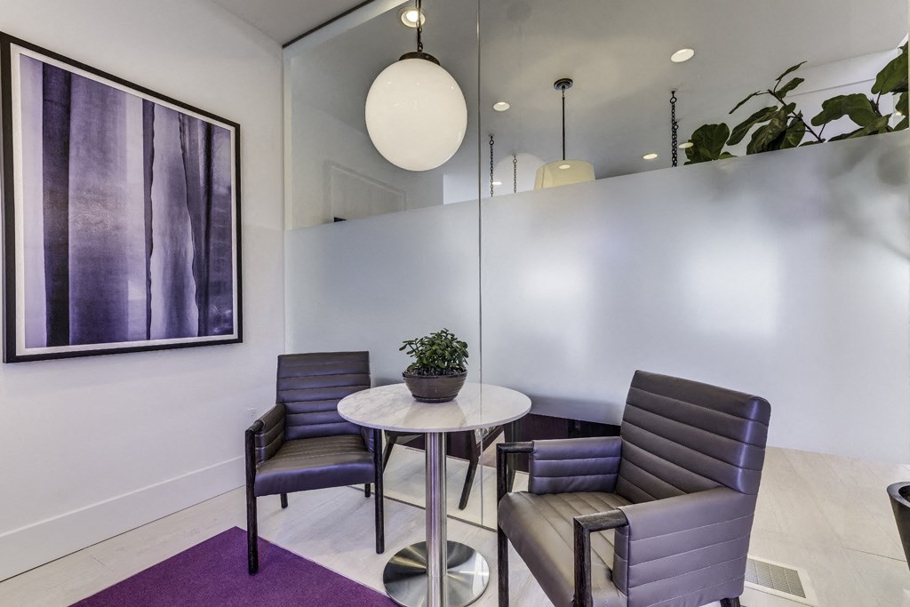 a living room with a table and chairs