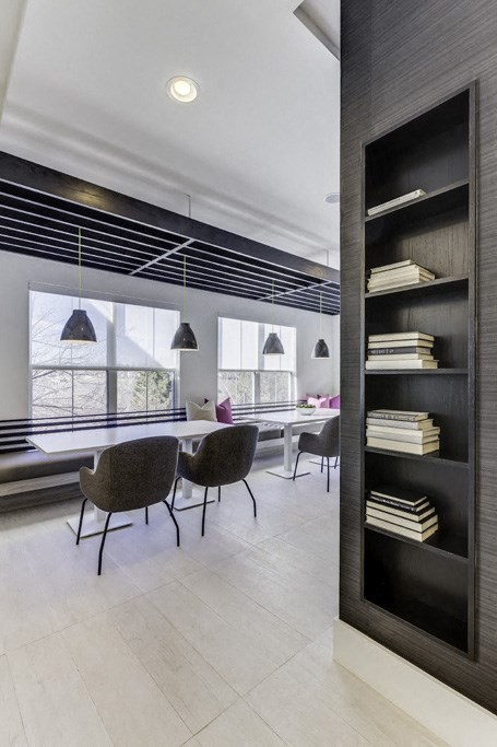 a dining room with a table and chairs and a bookshelf