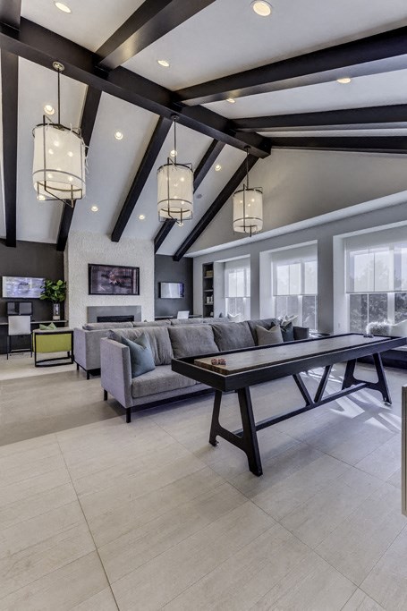 a large living room with a table and a couch