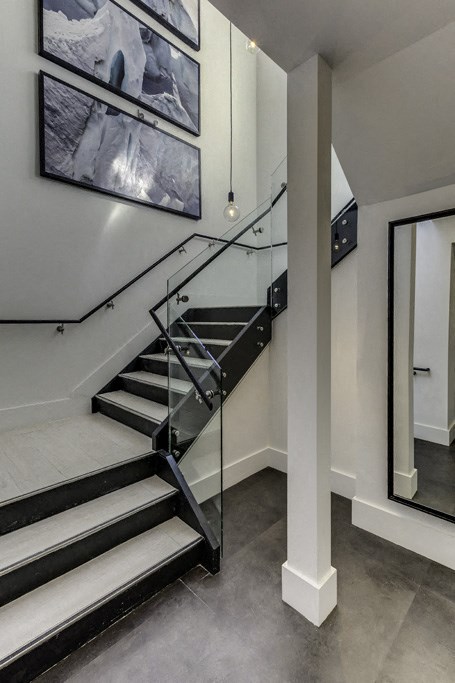 a staircase with glass railings in a modern home