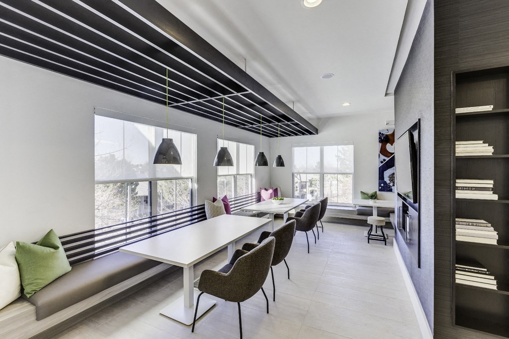 a dining room with tables and chairs and a large window