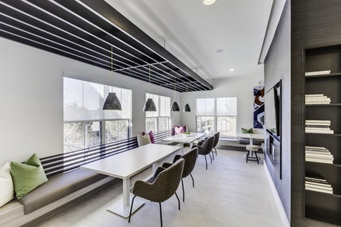a dining room with tables and chairs and a large window