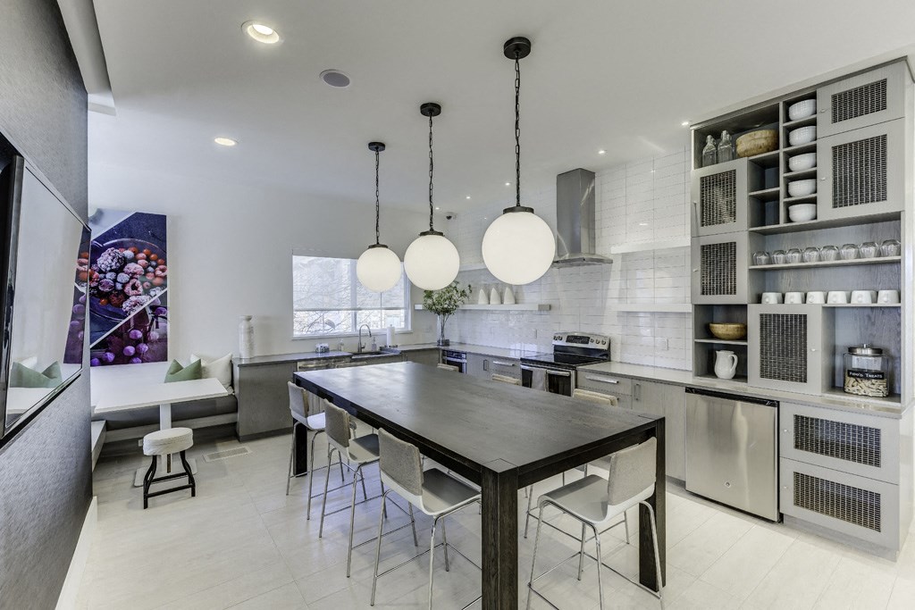 a large kitchen with a long table and chairs