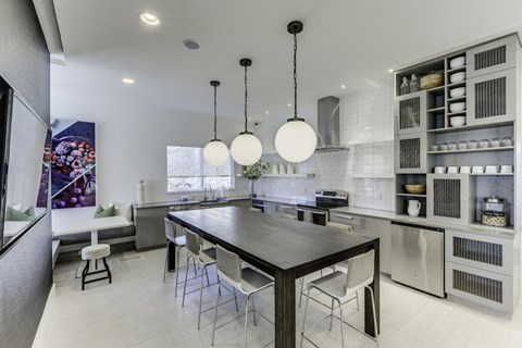 a large kitchen with a long table and chairs