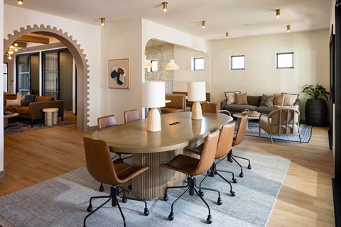 A modern dining room with a round table and chairs.