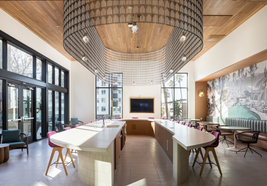 a large dining room with a long table and chairs and a large window